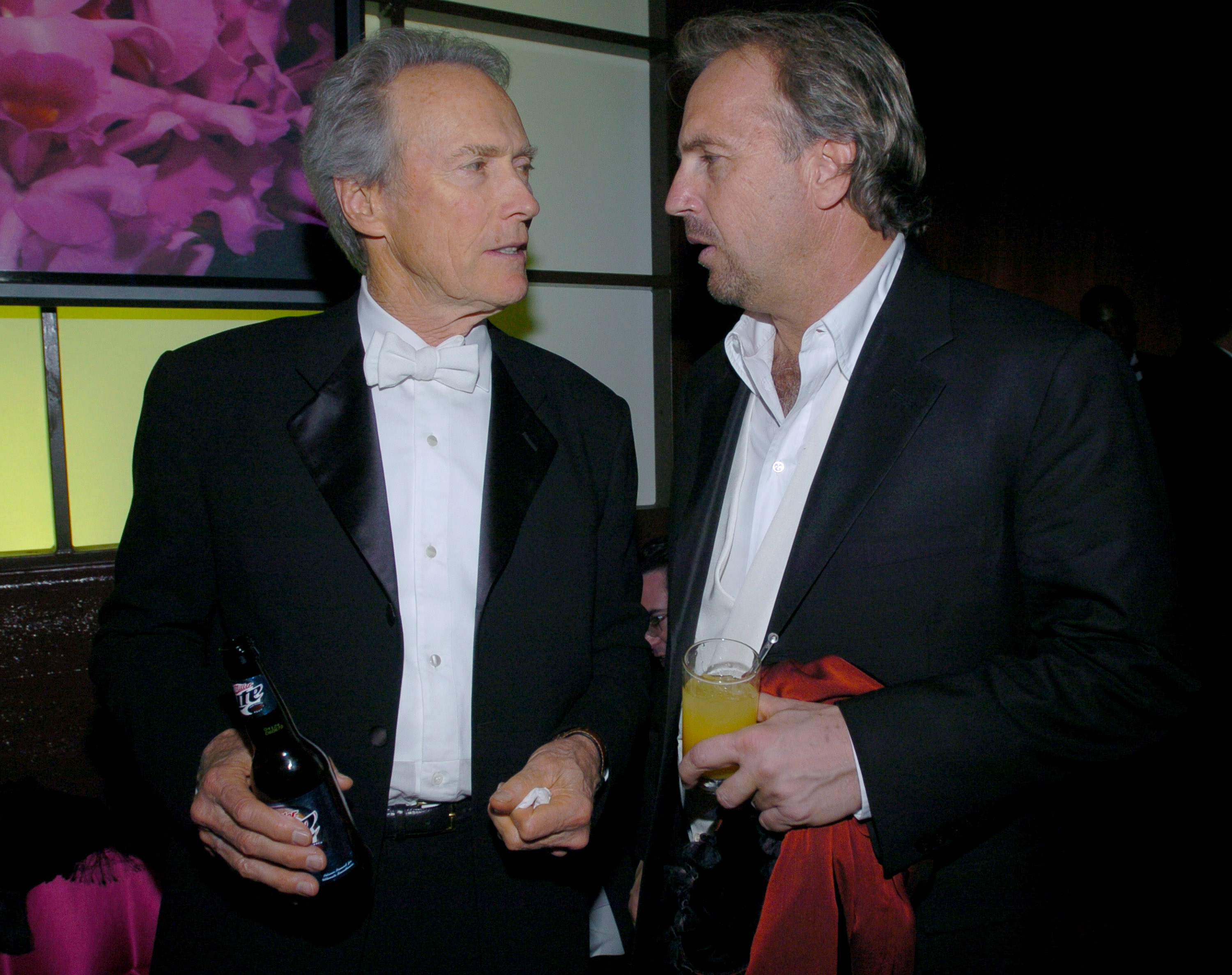 Clint Eastwood and Kevin Costner talking at a Golden Globe after-party.
