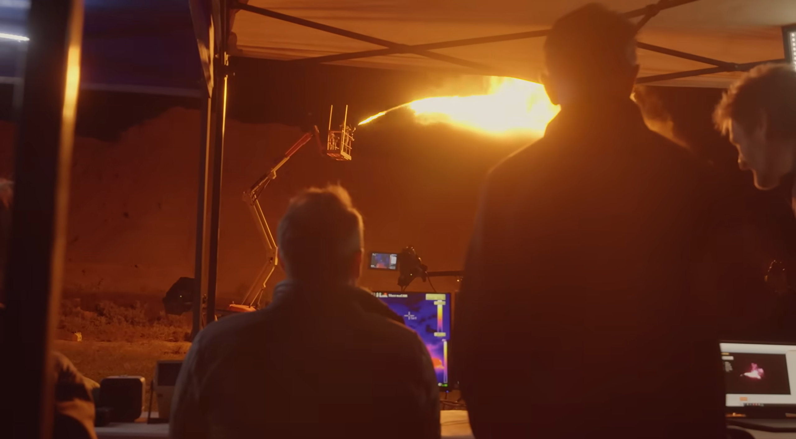 Travis Taylor examines a moving anomaly beneath the rocket flame.
