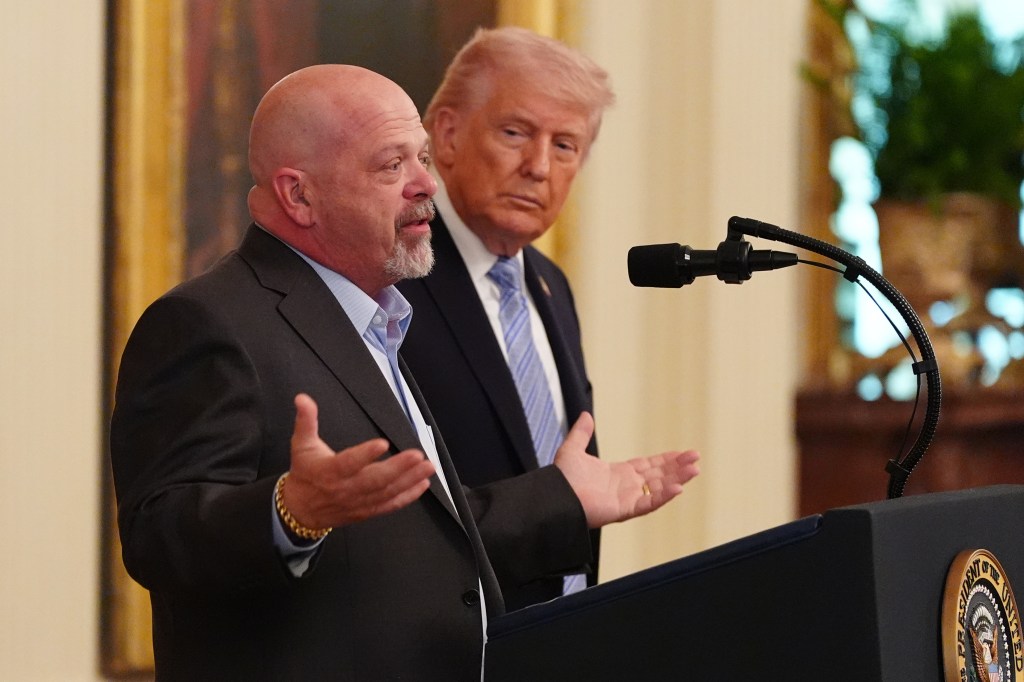 President Donald Trump listens as Rick Harrison speaks during an event