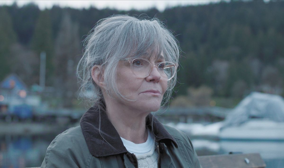 A woman with grey hair looks sad 