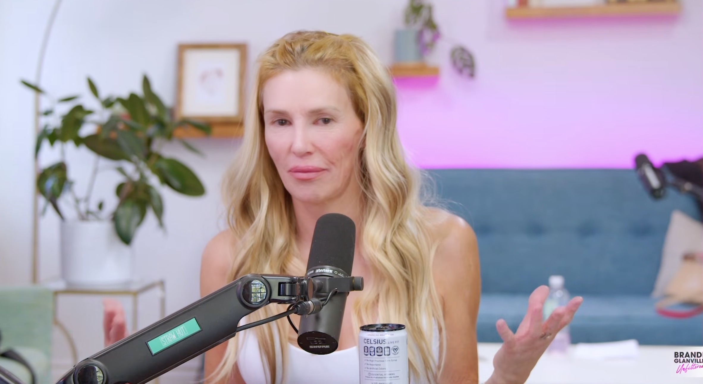 Brandi Glanville with a microphone in front of her.
