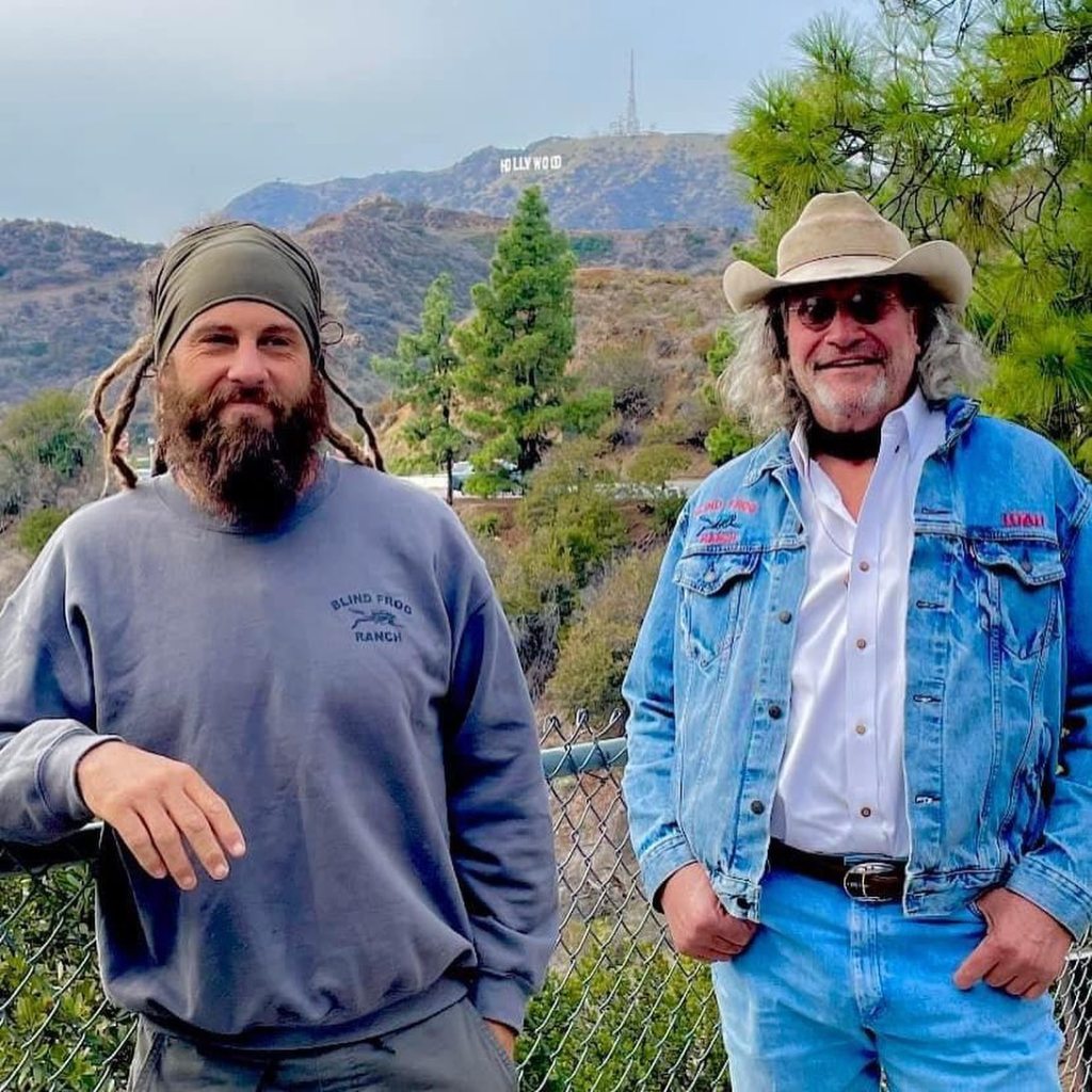 Duane and Chad Ollinger posing with the Hollywood sign in the background.