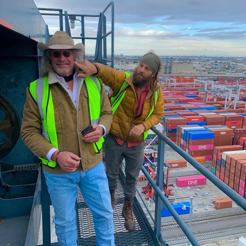 Duane and Chad Ollinger in safety vests at a shipping yard.