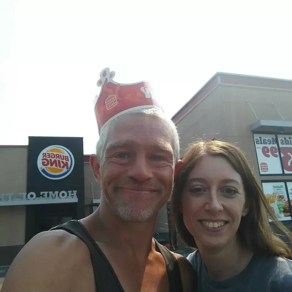 Alaskan Bush People star Matt Brown and a woman posing for a selfie in front of a Burger King restaurant.