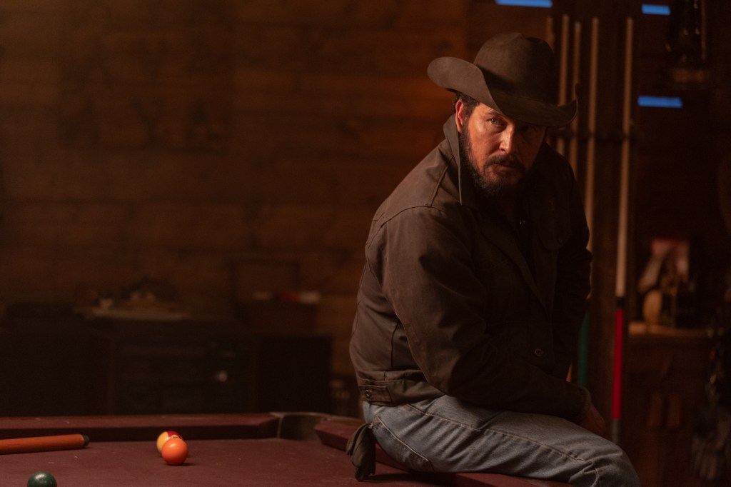 Cole Hauser as Rip Wheeler sitting on a pool table.